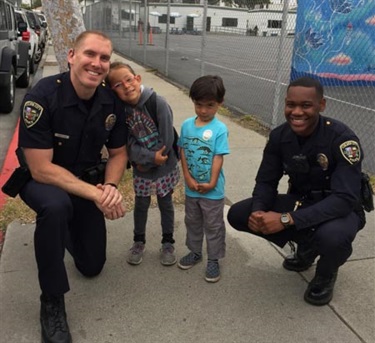 Special enforcement team members with kids at their school.